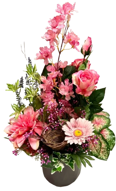 Composition de fleurs artificielles funéraires dans les tons roses et blancs.